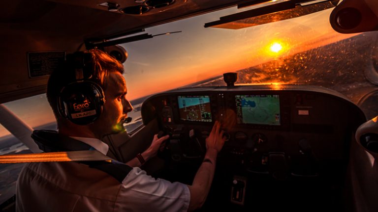 inside airplane cockpit with pilot