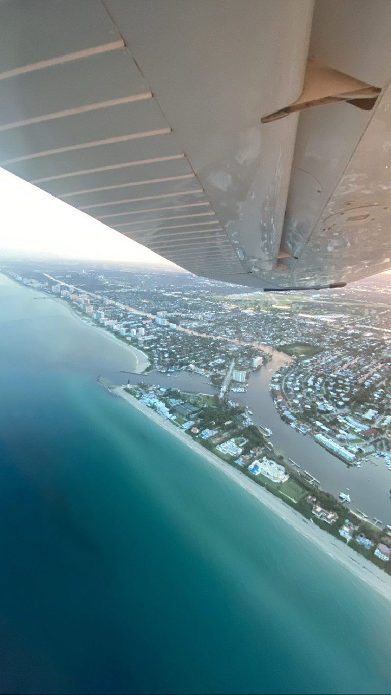 Cessna flying above water and Florida