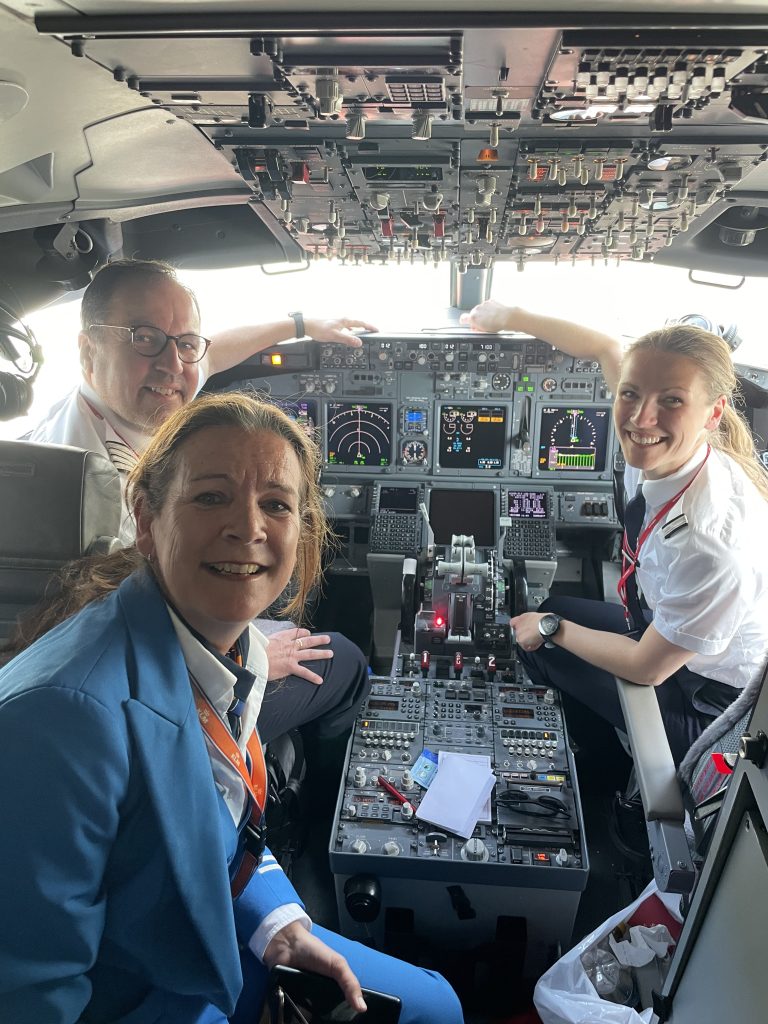 two women in cockpit and captain